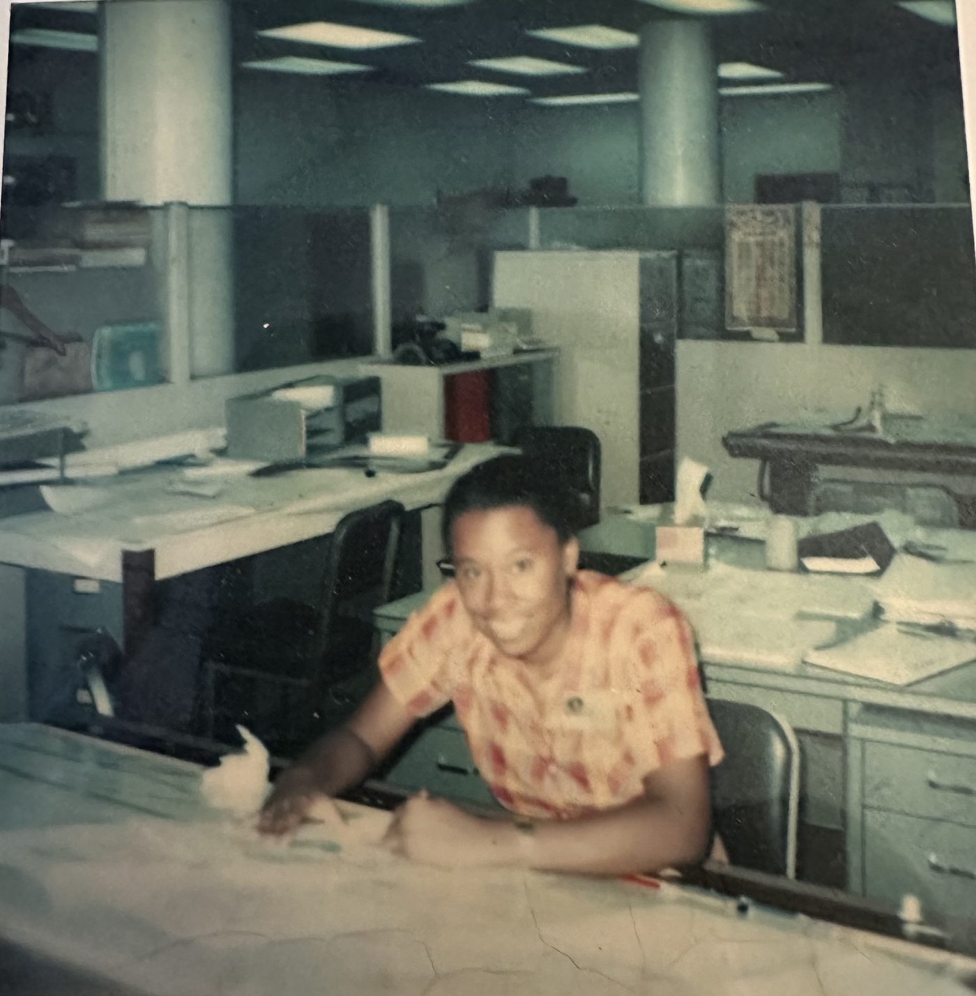 Dr. Beverly Yates early in her engineering career, at a drafting table in a Silicon Valley office